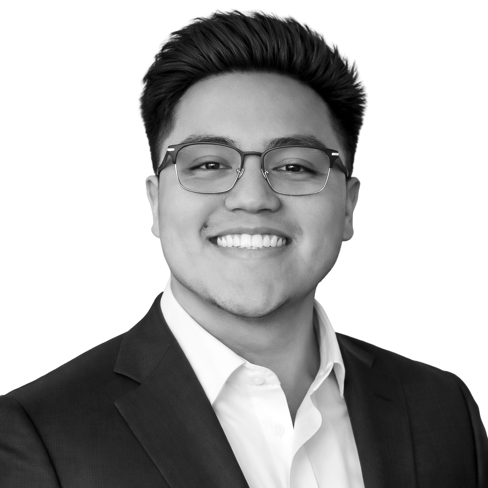 Smiling man in a suit and glasses, cropped head-and-shoulders portrait (black-and-white).